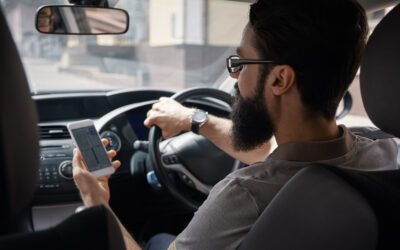 Man using mobile phone while driving.