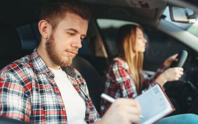 Male instructor and female student, driving lesson