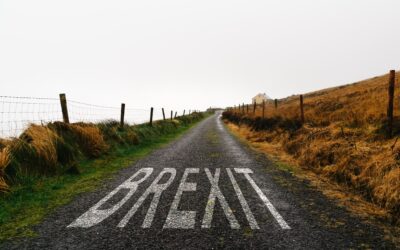 Road marking with the word Brexit painted on remote road a misty