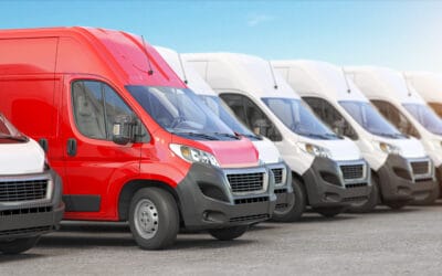 Red delivery van in a row of white vans.